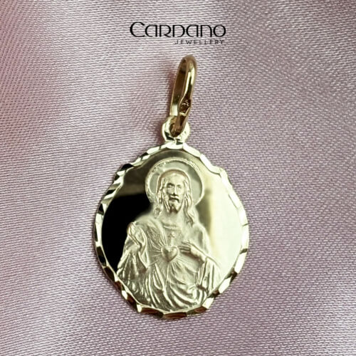 Elegancki złoty medalik z wizerunkiem Jezusa.
